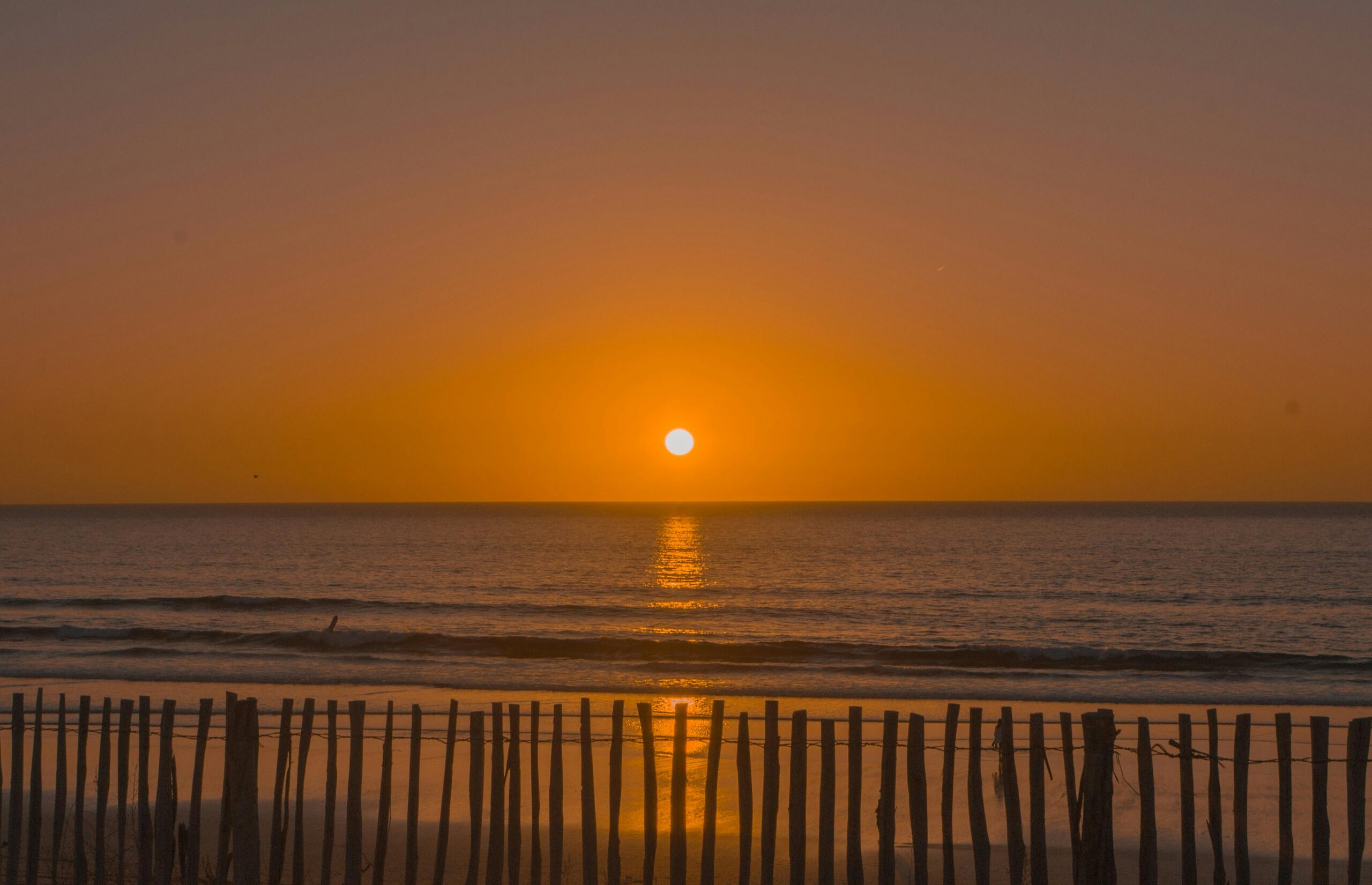 Breathtaking sunset over the Atlantic Ocean in Morocco, reflecting vibrant colors.