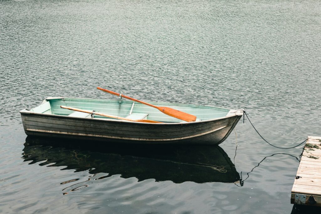 A serene image of a rowboat moored on a calm lake in Gatineau, Quebec, Canada.