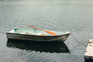 A serene image of a rowboat moored on a calm lake in Gatineau, Quebec, Canada.