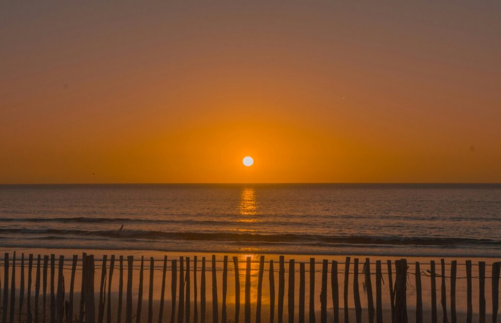 Breathtaking sunset over the Atlantic Ocean in Morocco, reflecting vibrant colors.