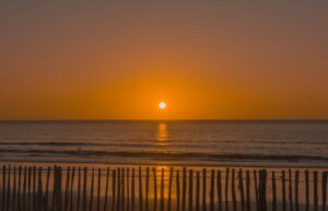 Breathtaking sunset over the Atlantic Ocean in Morocco, reflecting vibrant colors.